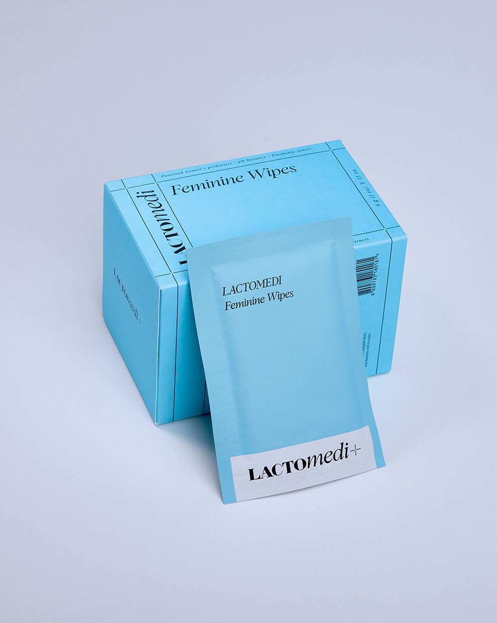 A box of feminine wipes with one individually wrapped packet